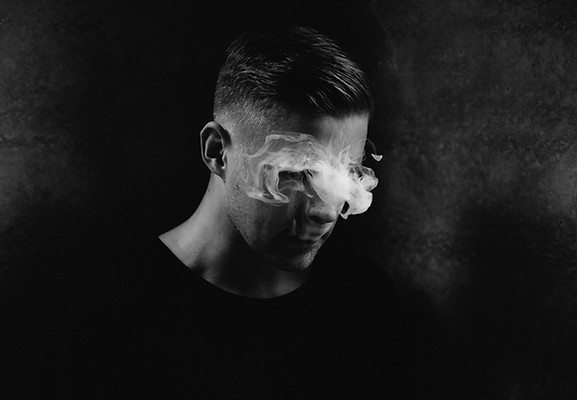 It's Indie, black and white man, smoke over eyes