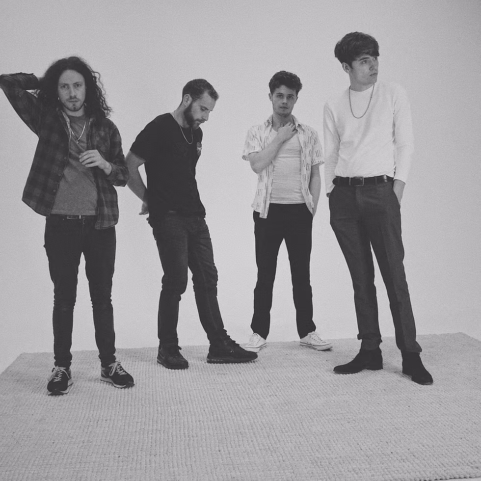 A black and white photo of four me, the band "The Trusted" as featured on It's Indie and we know it